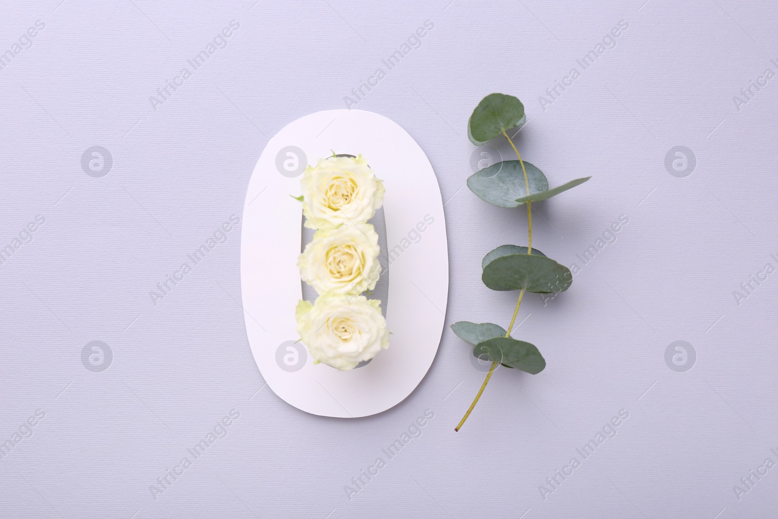 Photo of Paper number 0, beautiful flowers and eucalyptus branch on light grey background, top view