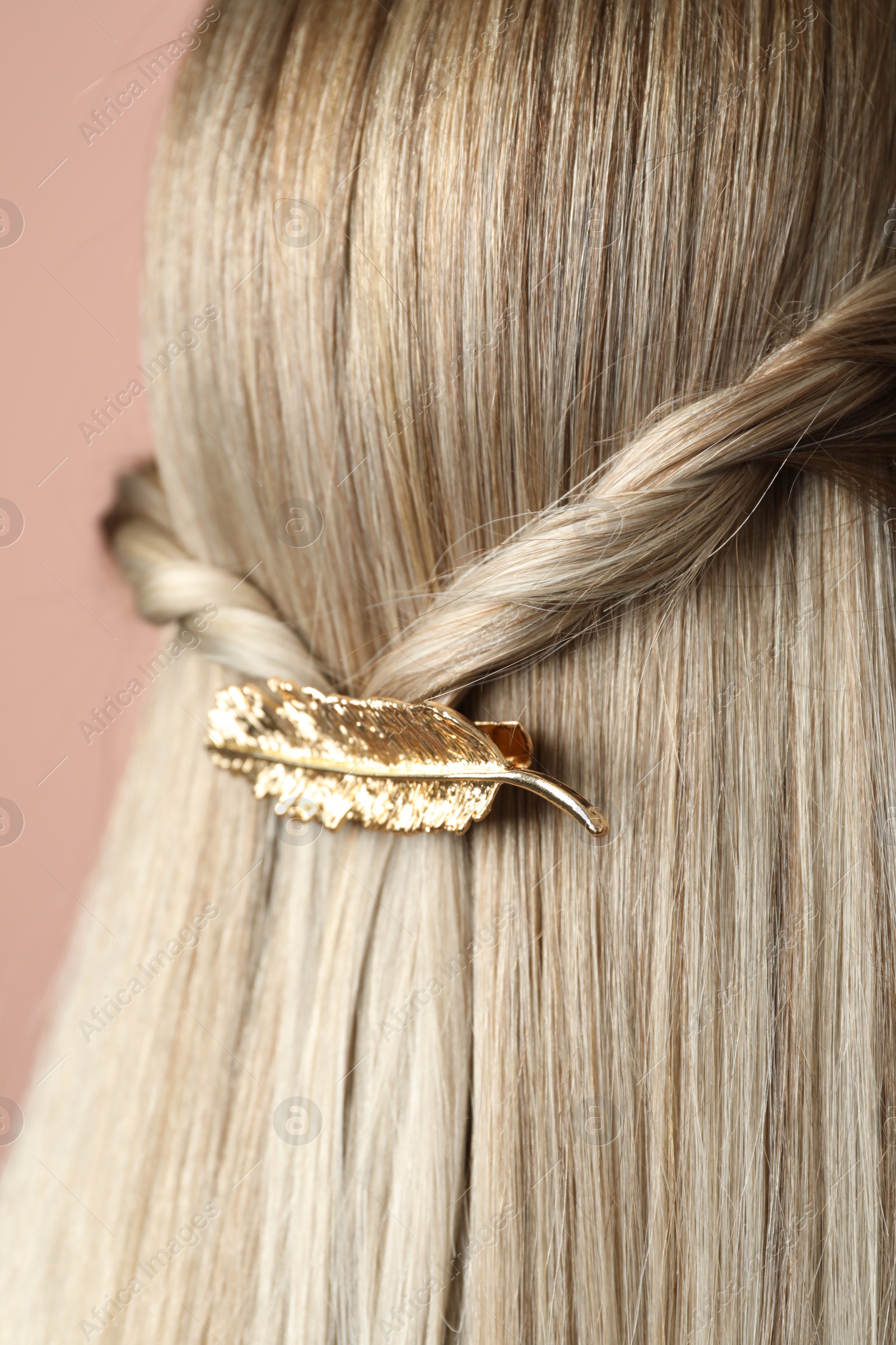 Photo of Woman with beautiful gold hair clip, closeup