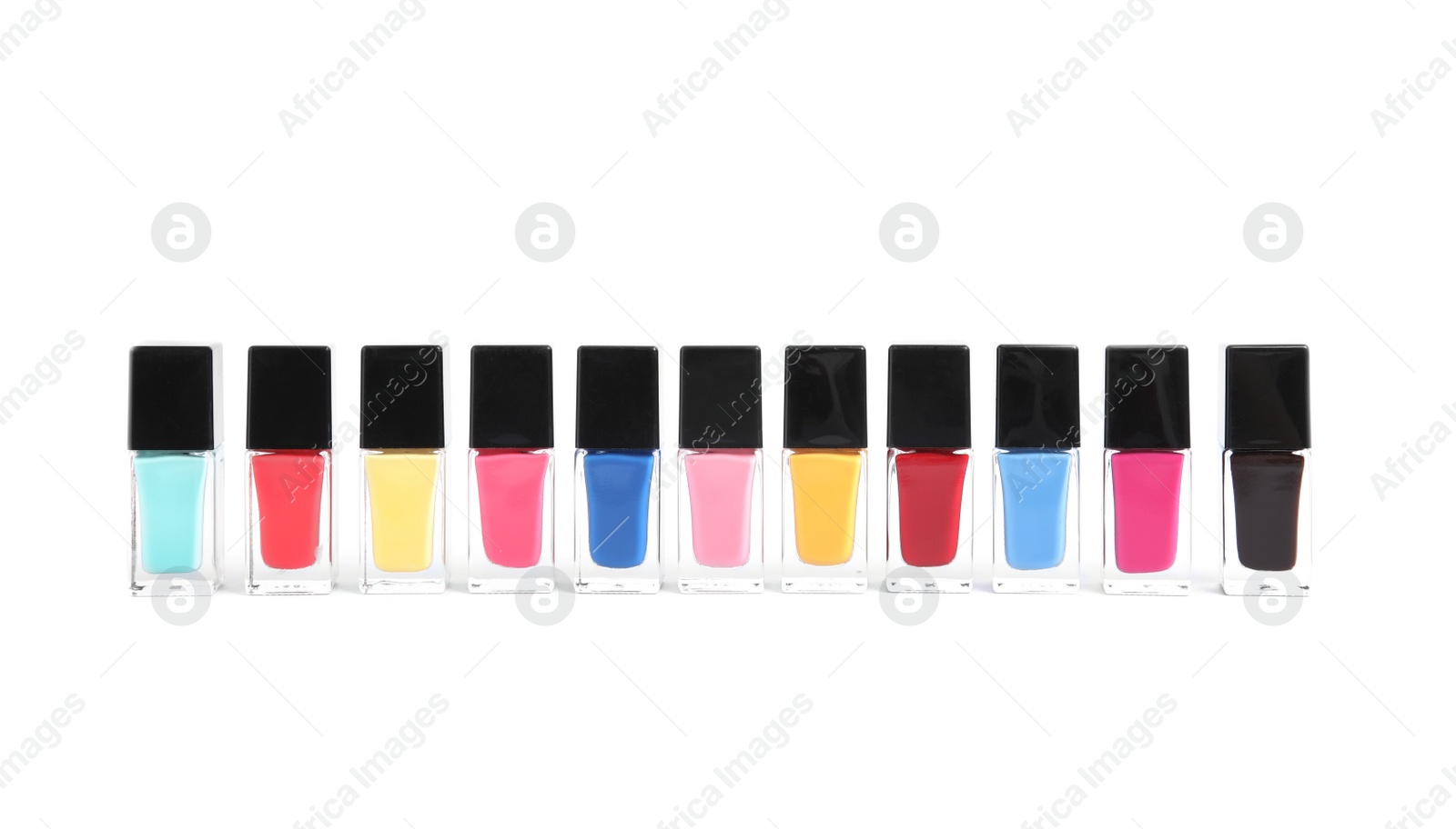 Photo of Bottles of nail polish on white background