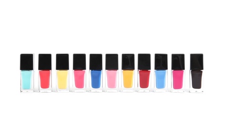 Photo of Bottles of nail polish on white background