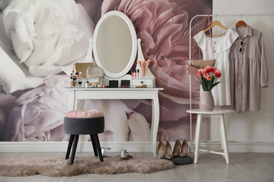 Stylish room interior with elegant dressing table and floral wallpaper