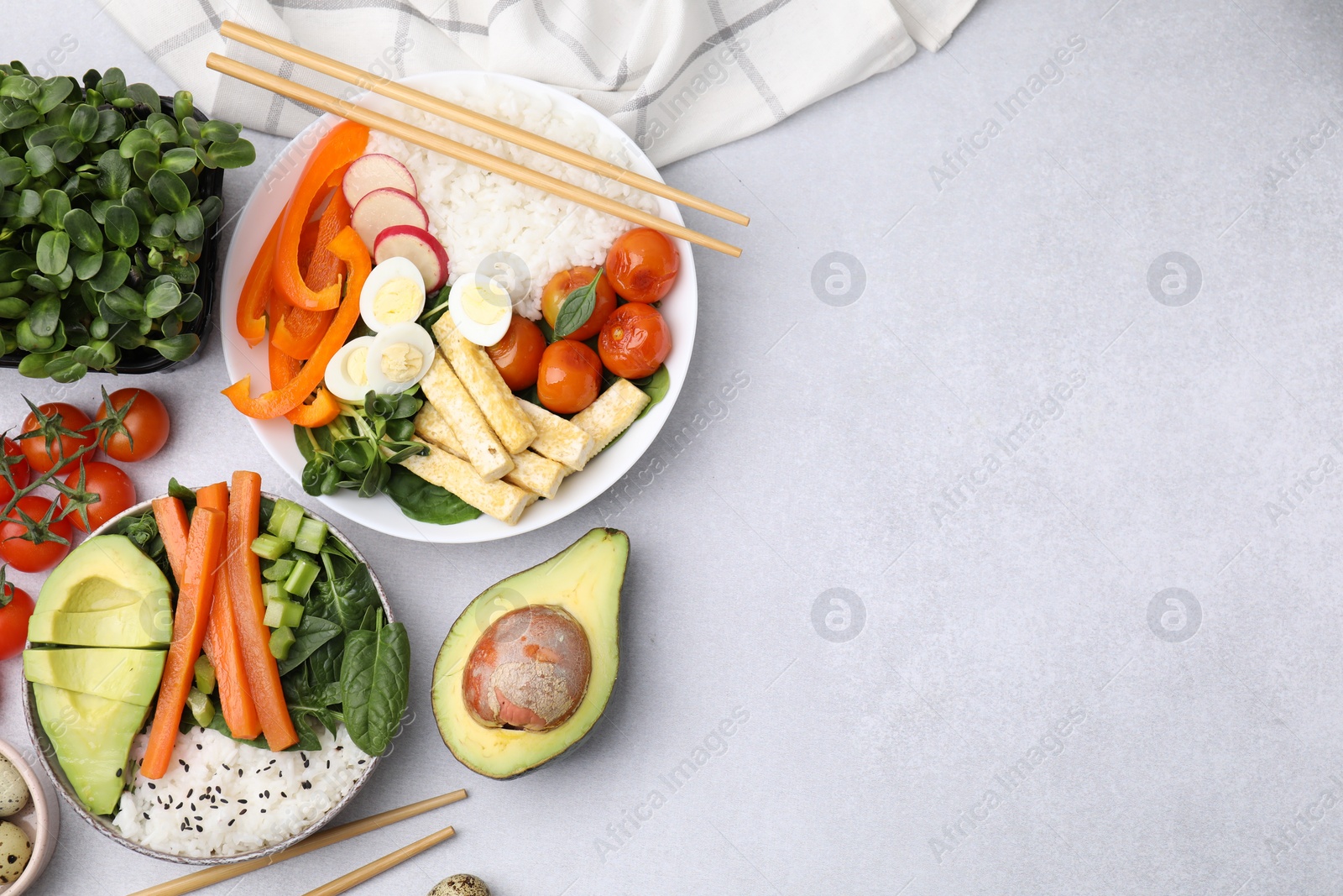 Photo of Delicious poke bowl and ingredients on light grey background, flat lay. Space for text