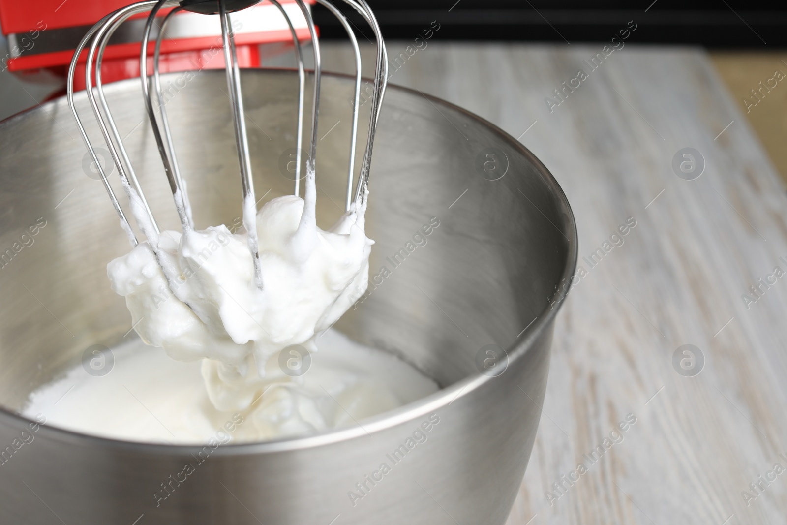 Photo of Modern stand mixer on wooden table indoors, closeup. Space for text