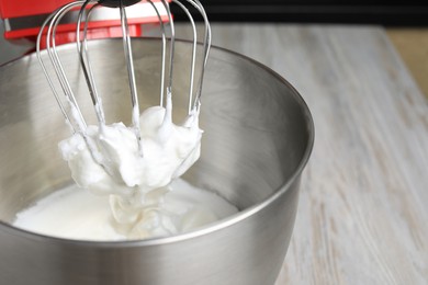 Photo of Modern stand mixer on wooden table indoors, closeup. Space for text