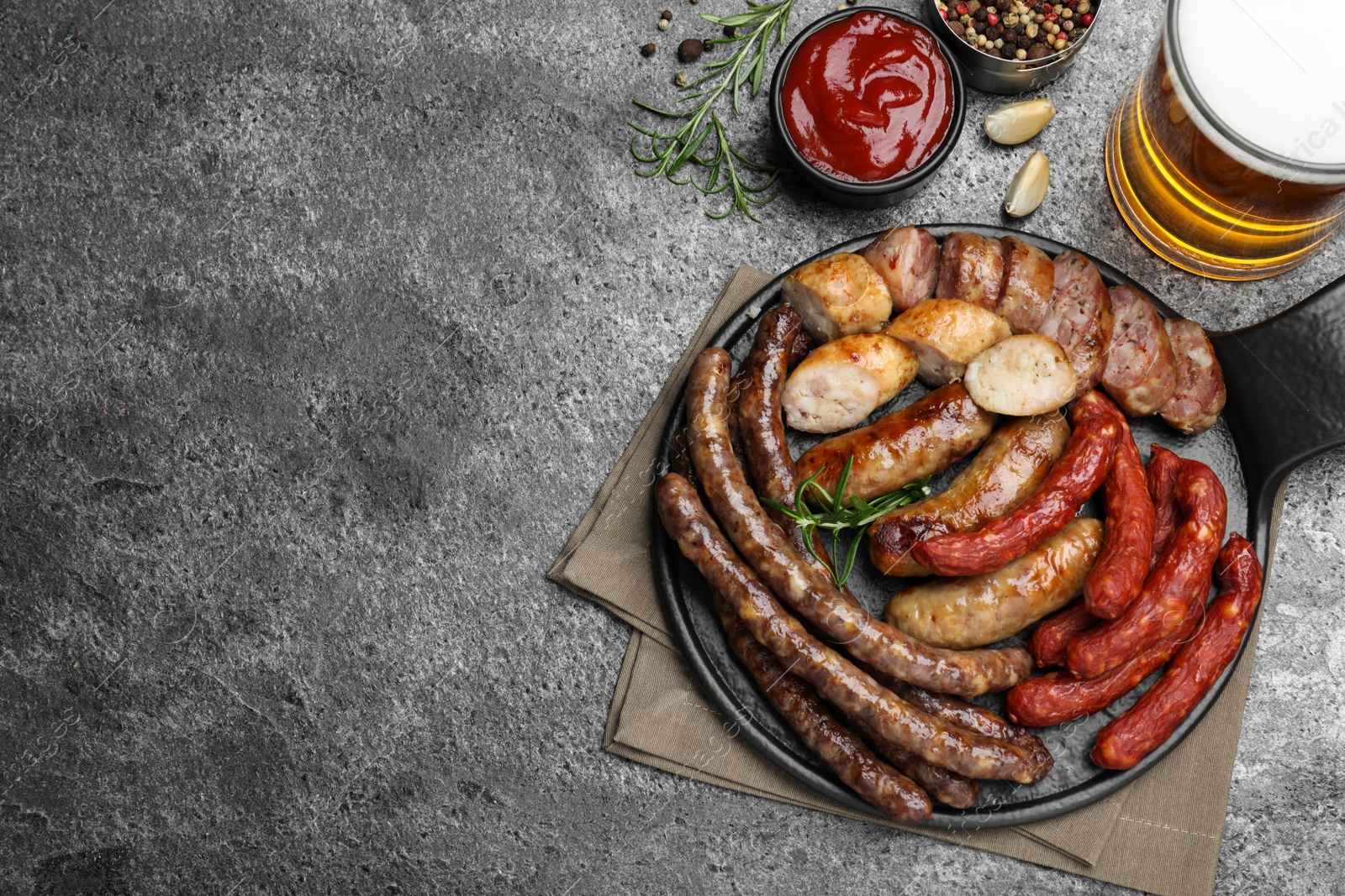 Photo of Set of different tasty snacks and beer on dark grey table, flat lay. Space for text