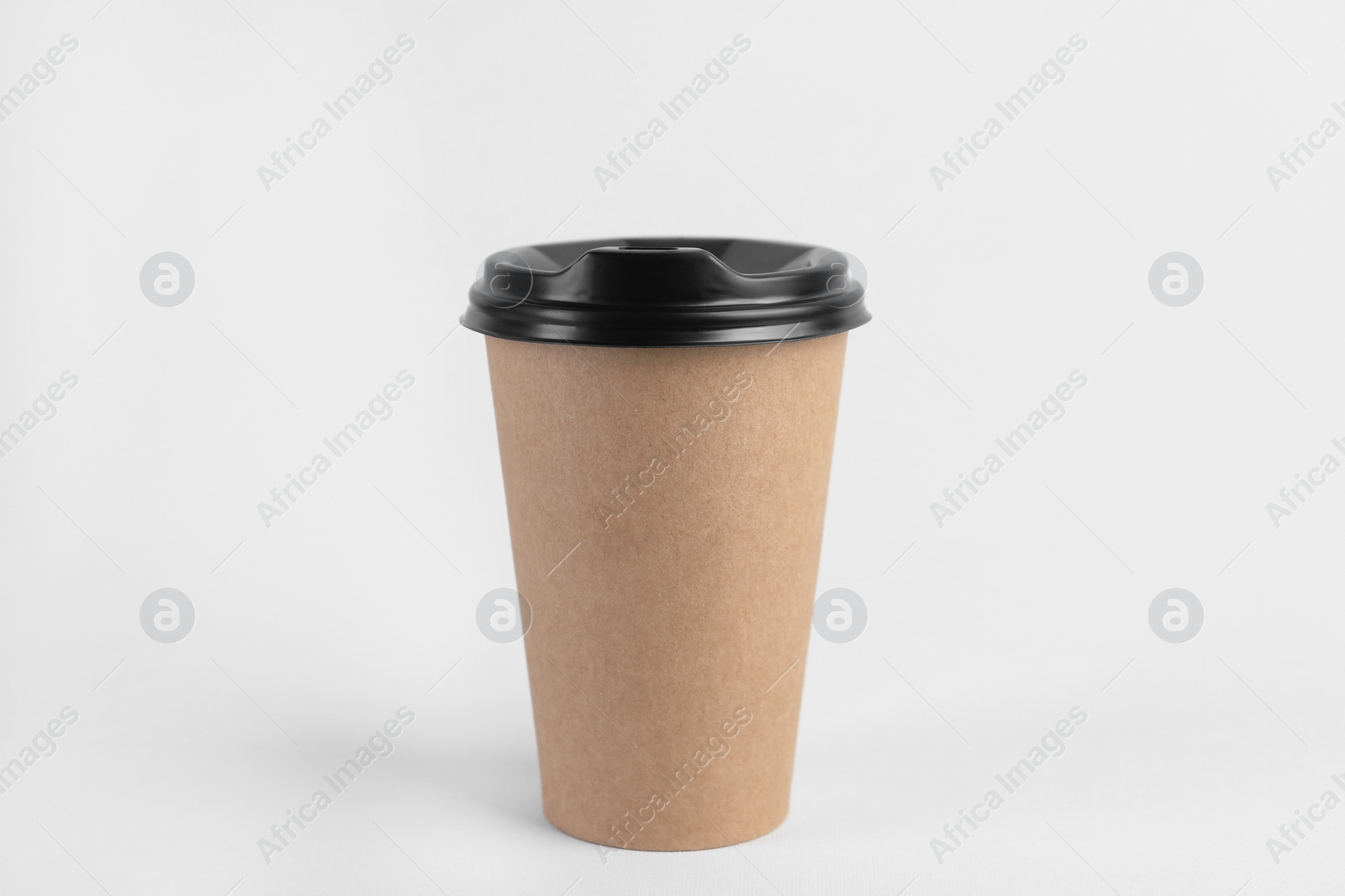 Photo of Paper cup with plastic lid on light background. Coffee to go