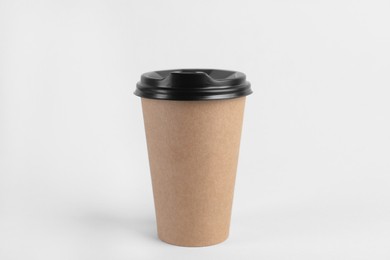 Paper cup with plastic lid on light background. Coffee to go