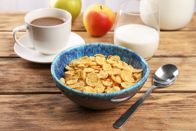 Bowl with healthy cornflakes for breakfast served on wooden table