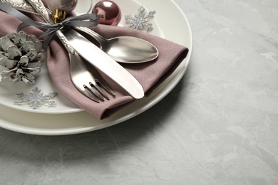 Beautiful Christmas table setting on light grey marble background. Space for text