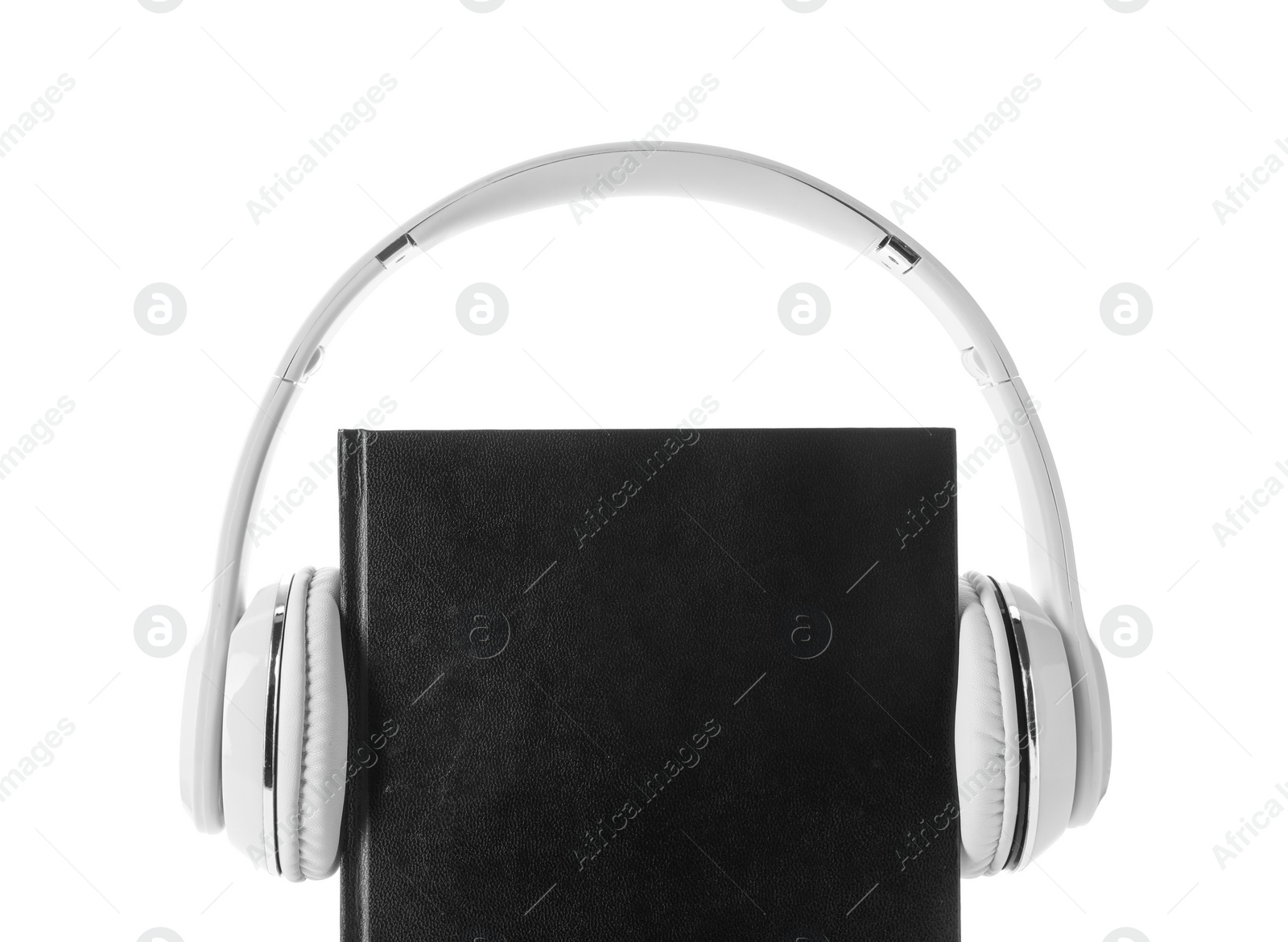 Photo of Bible and headphones on white background. Religious audiobook