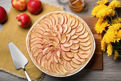 Photo of Flat lay composition with tasty apple pie on wooden table