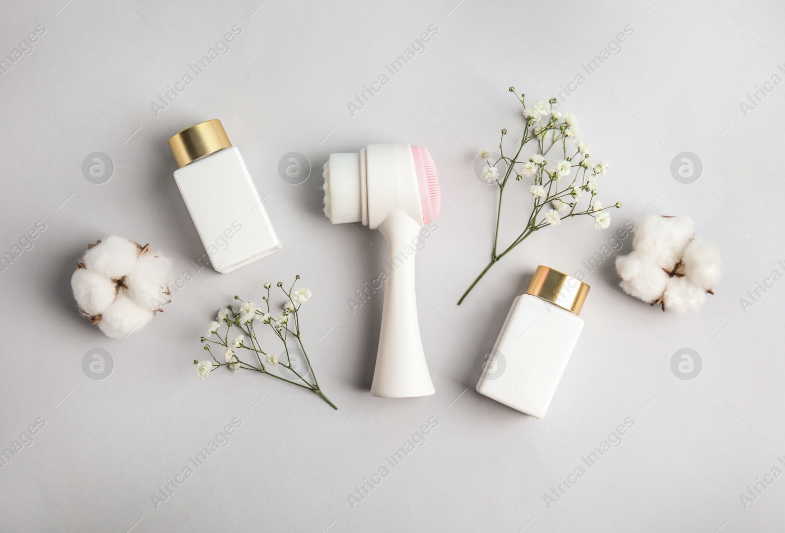 Photo of Flat lay composition with face cleansing brush on light grey background. Cosmetic accessory