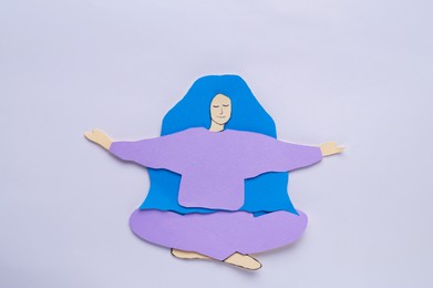Photo of Woman's health. Female paper figure on white background, top view