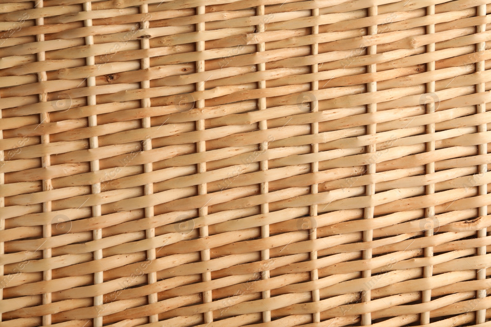 Photo of Handmade wicker basket made of natural material as background, closeup view