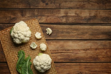 Fresh cauliflower on wooden table, top view. Space for text