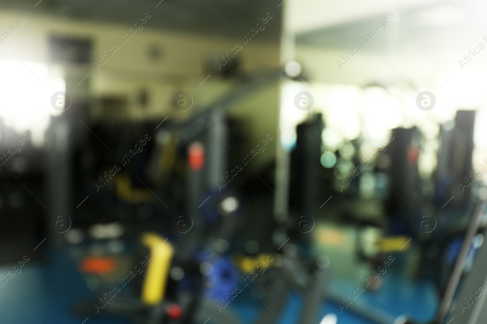 Photo of Blurred view of gym with modern equipment