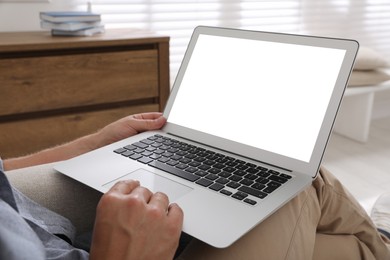 Photo of Man with modern laptop indoors, closeup. Space for design