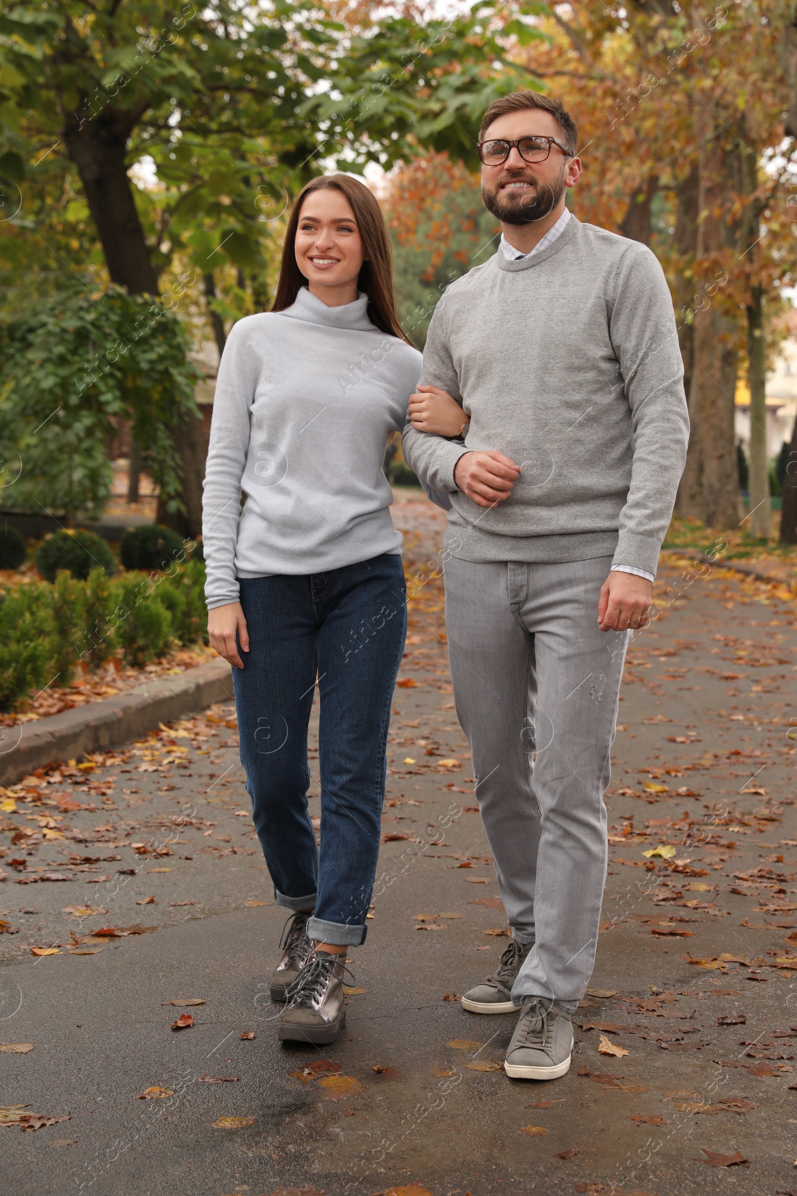 Photo of Happy couple wearing stylish clothes in autumn park