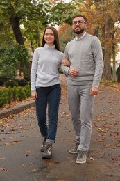 Happy couple wearing stylish clothes in autumn park