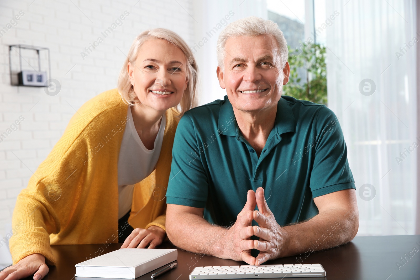 Photo of Mature couple using video chat at home, view from web camera