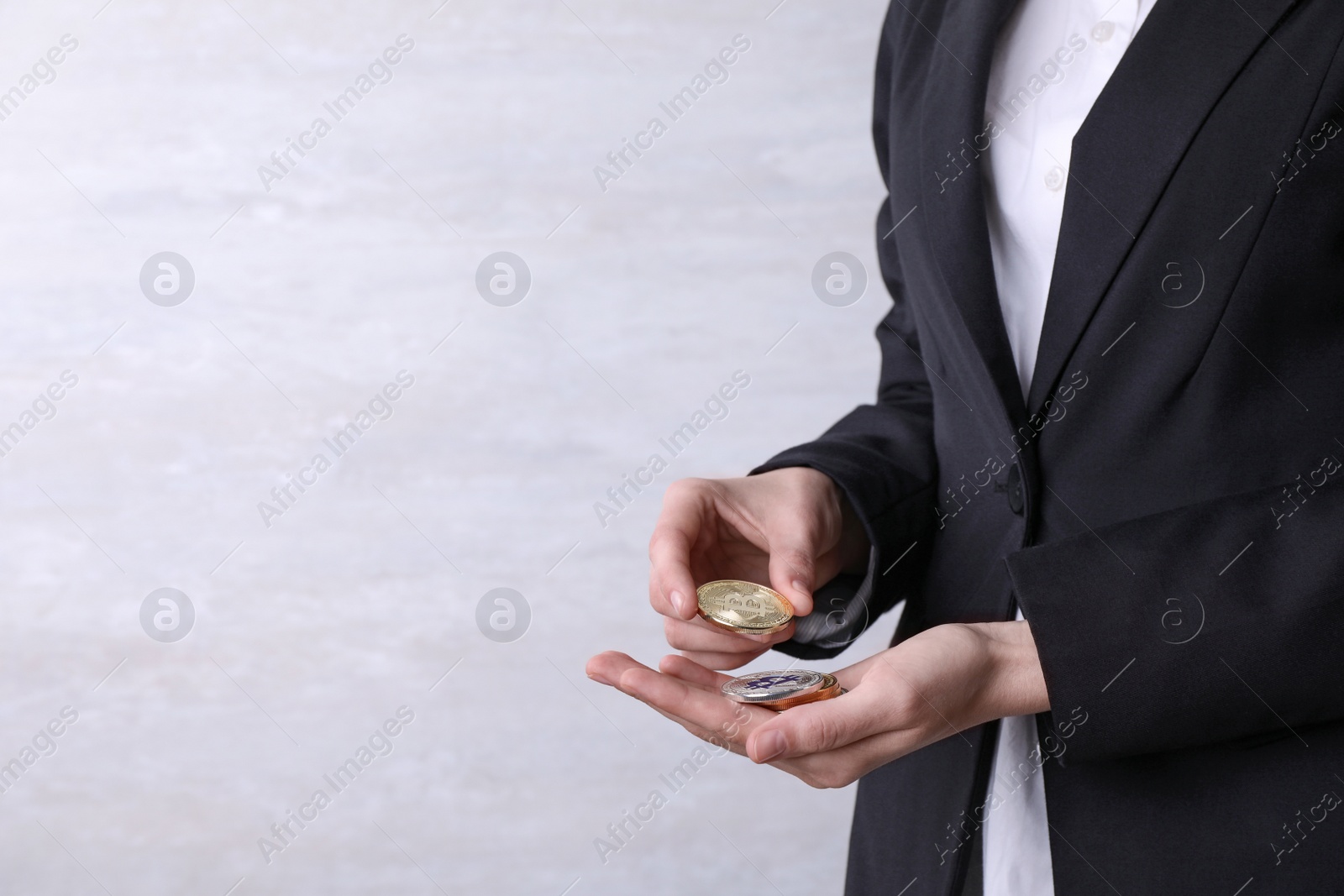 Photo of Person holding bitcoins on light background, closeup. Space for text