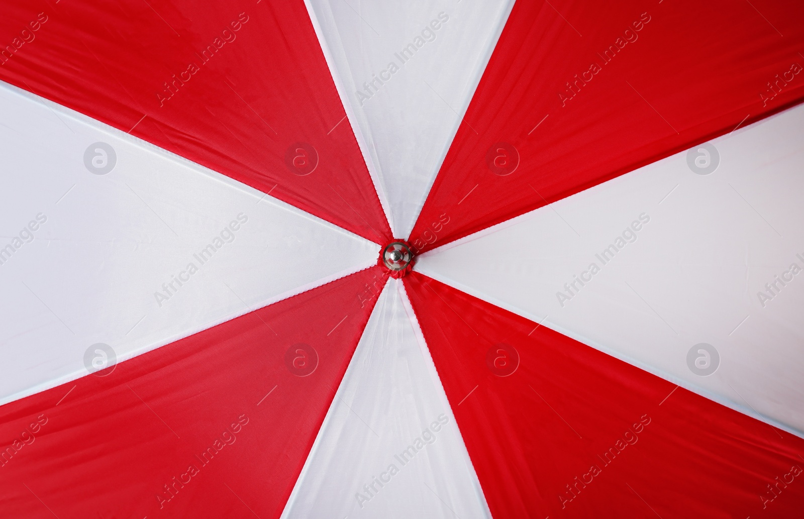 Image of Bright red and white umbrella as background, closeup