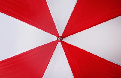 Image of Bright red and white umbrella as background, closeup