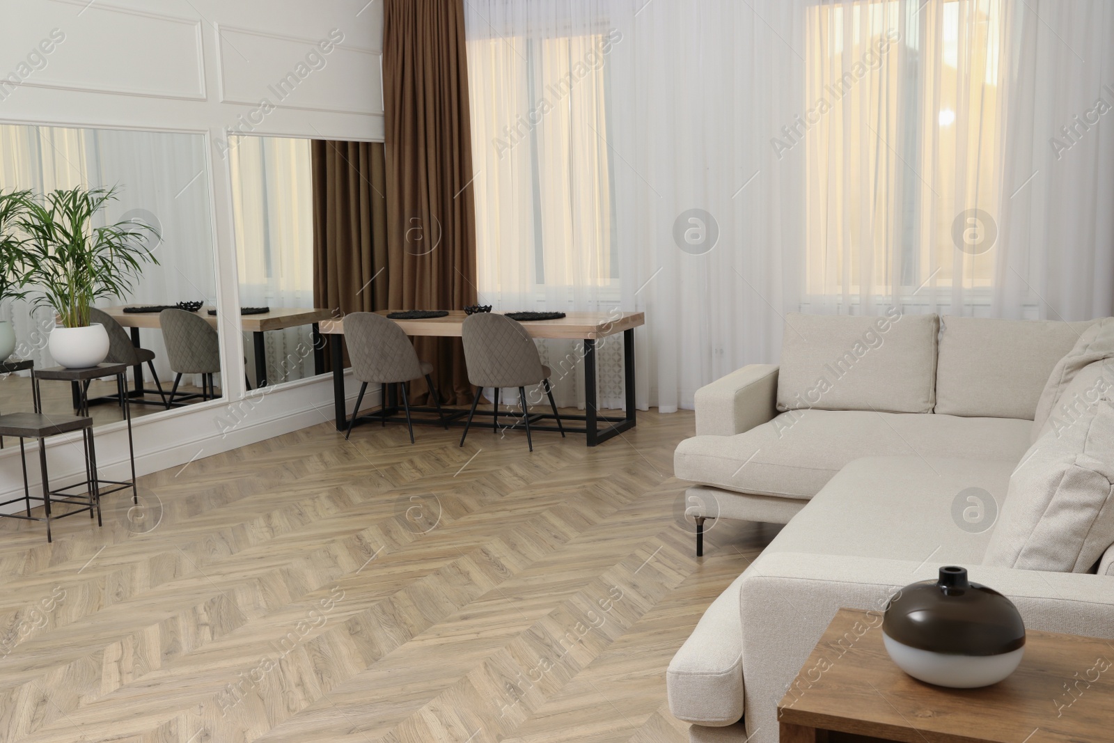 Photo of Modern living room with parquet flooring and stylish furniture