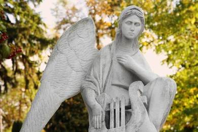 Photo of Beautiful statue of angel at cemetery. Funeral ceremony