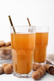 Tamarind juice and fresh fruits on white table