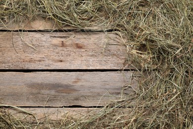 Photo of Frame made of dried hay on wooden table, top view. Space for text