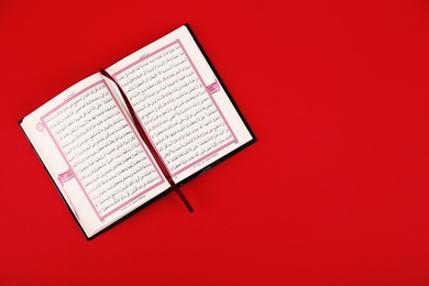 Photo of Quran and space for text on color background, top view. Muslim tradition