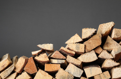 Cut firewood on grey background. Heating in winter