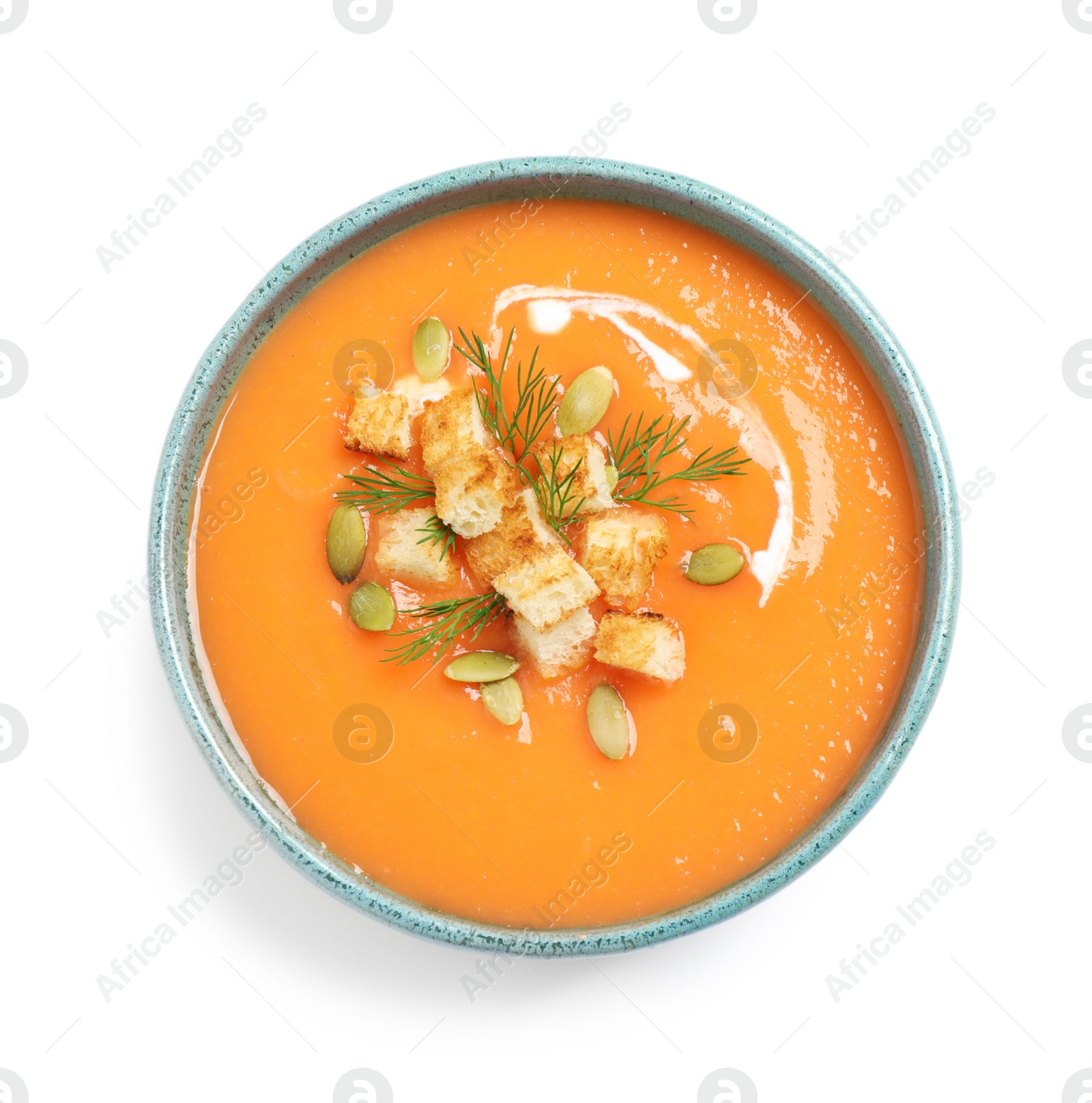 Photo of Delicious pumpkin soup in bowl isolated on white, top view