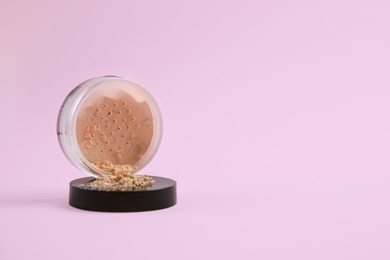 Photo of Loose face powder on pink background, space for text
