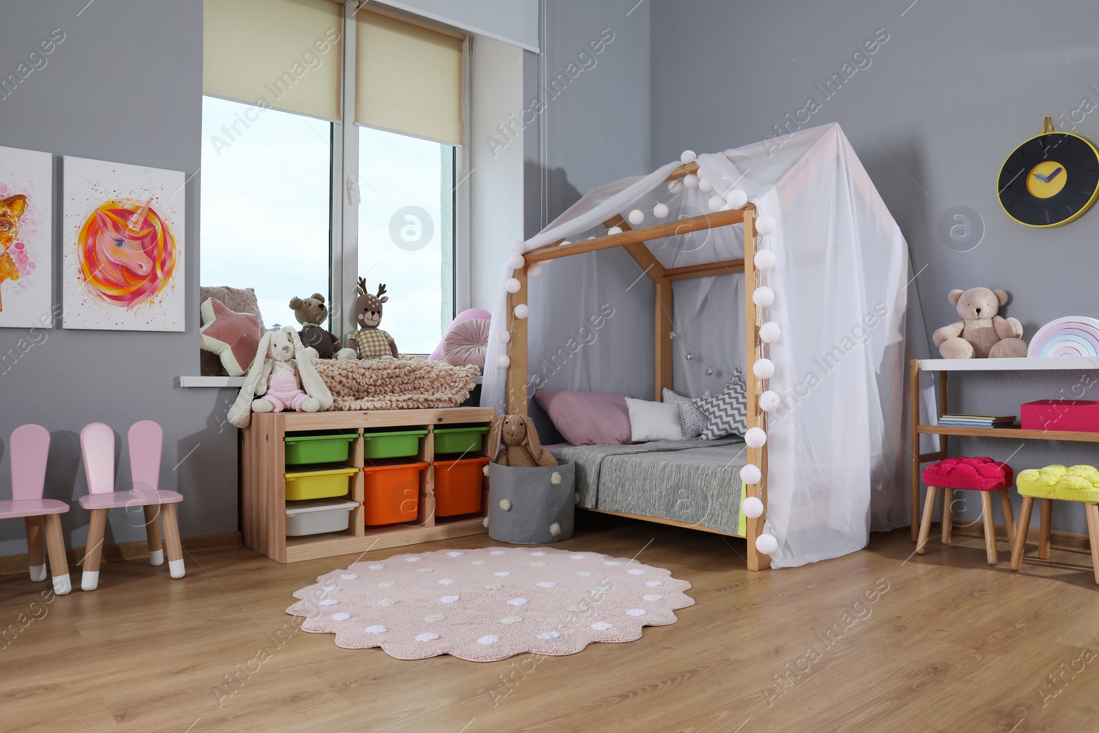 Photo of Stylish child room interior with comfortable house bed