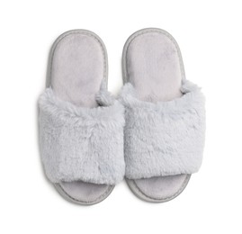 Photo of Pair of soft fluffy slippers on white background, top view
