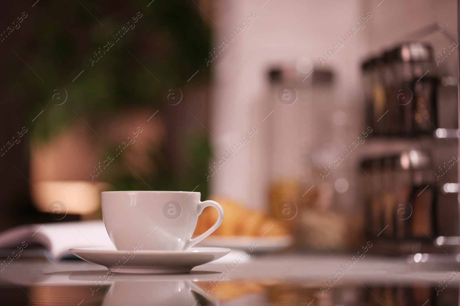 Photo of Cup of hot coffee on blurred background