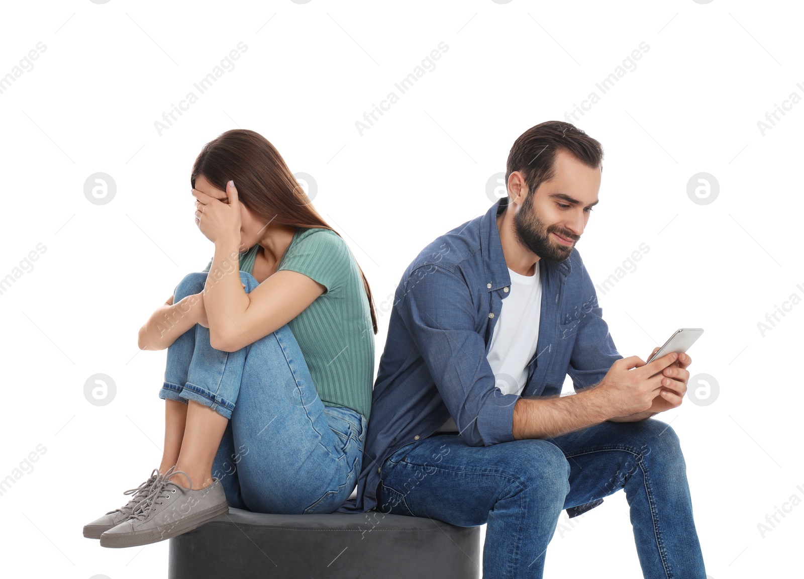 Photo of Man with smartphone ignoring his girlfriend on white background. Relationship problems