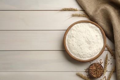 Photo of Flat lay composition with wheat flour on white wooden table. Space for text