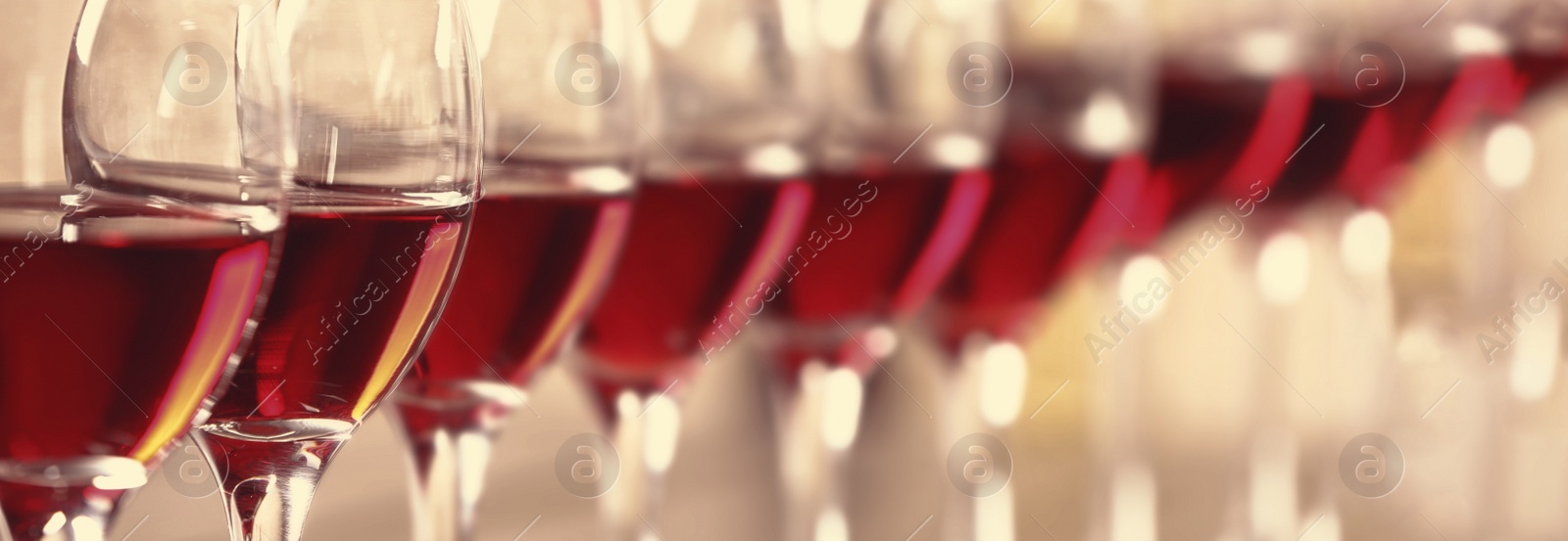 Image of Glasses with tasty red wine, closeup view. Banner design