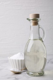 Vinegar and baking soda on white marble table