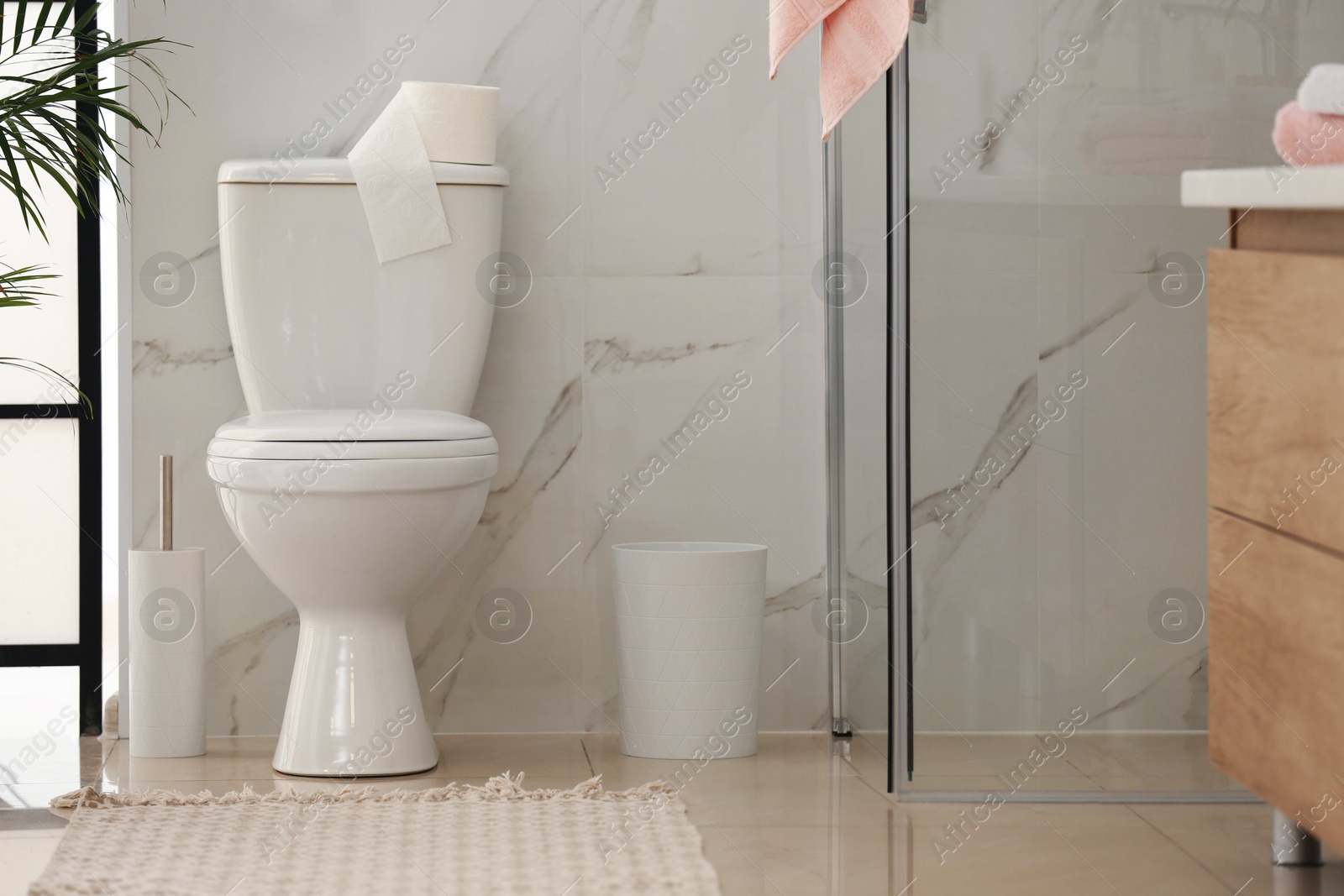 Photo of Interior of modern bathroom with toilet bowl