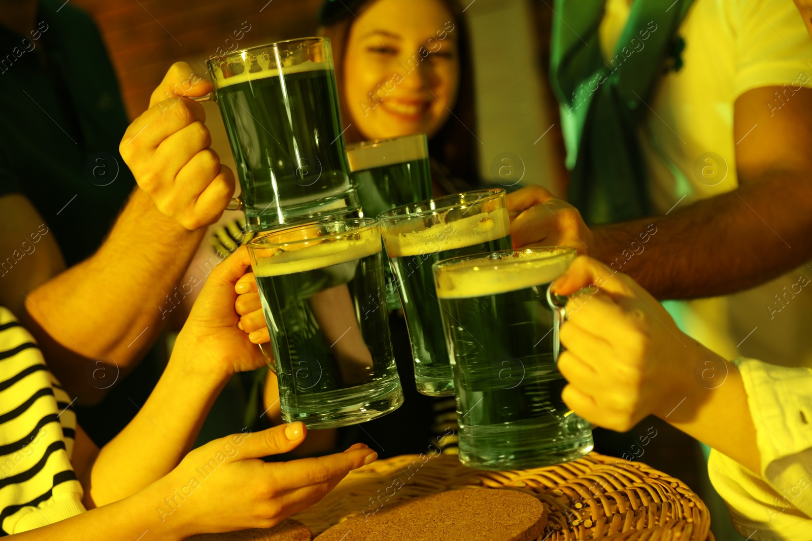 Photo of People with beer celebrating St Patrick's day in pub, closeup