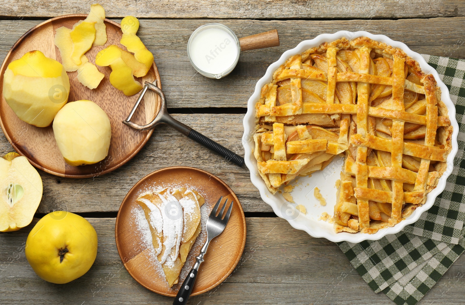 Photo of Tasty homemade quince pie, ingredients, peeler and fork on wooden table, flat lay