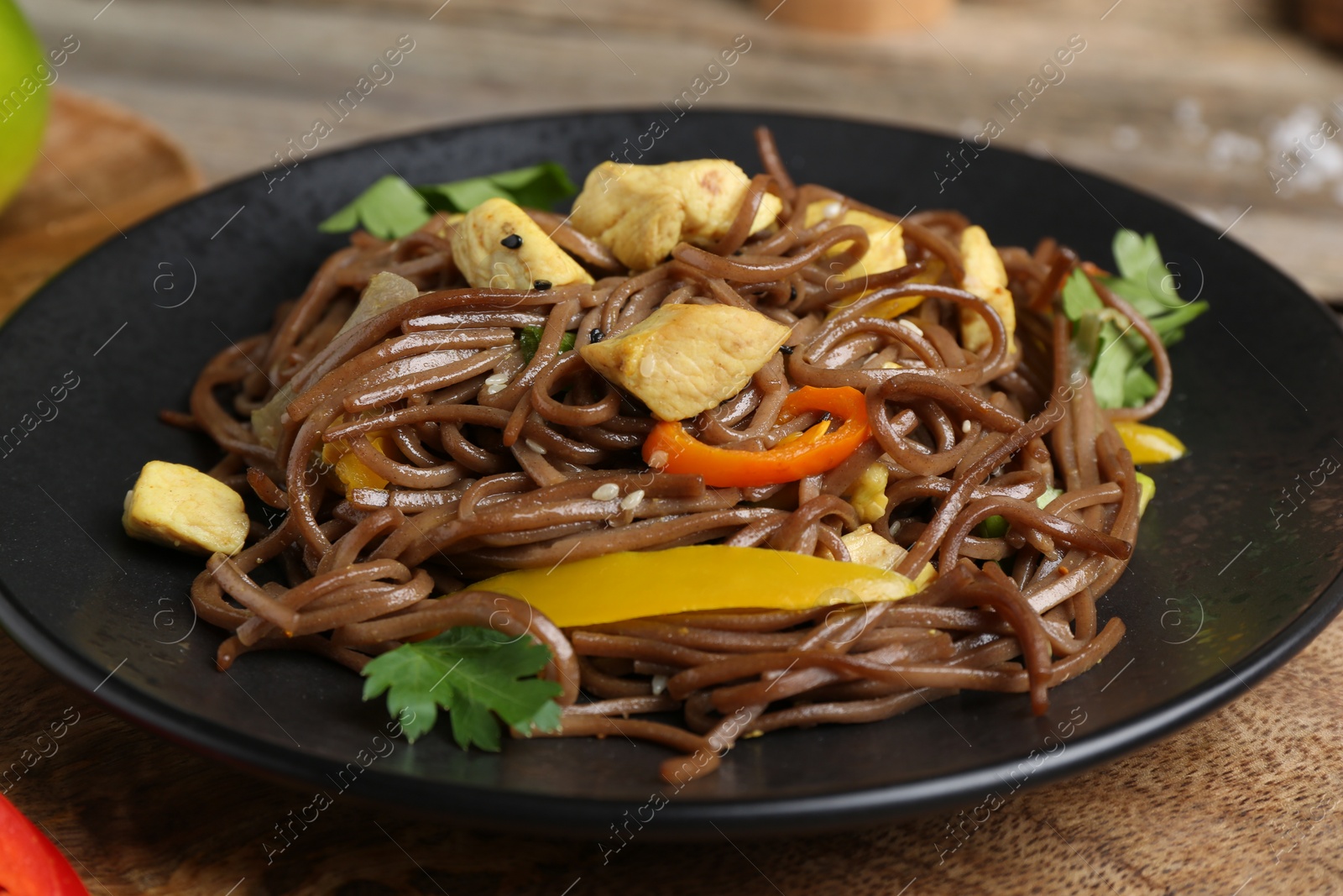 Photo of Stir-fry. Tasty noodles with vegetables and meat on table, closeup