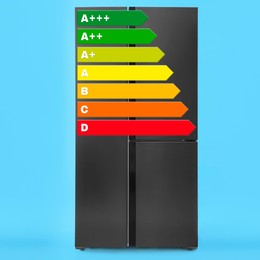 Image of Energy efficiency rating label and refrigerator on light blue background