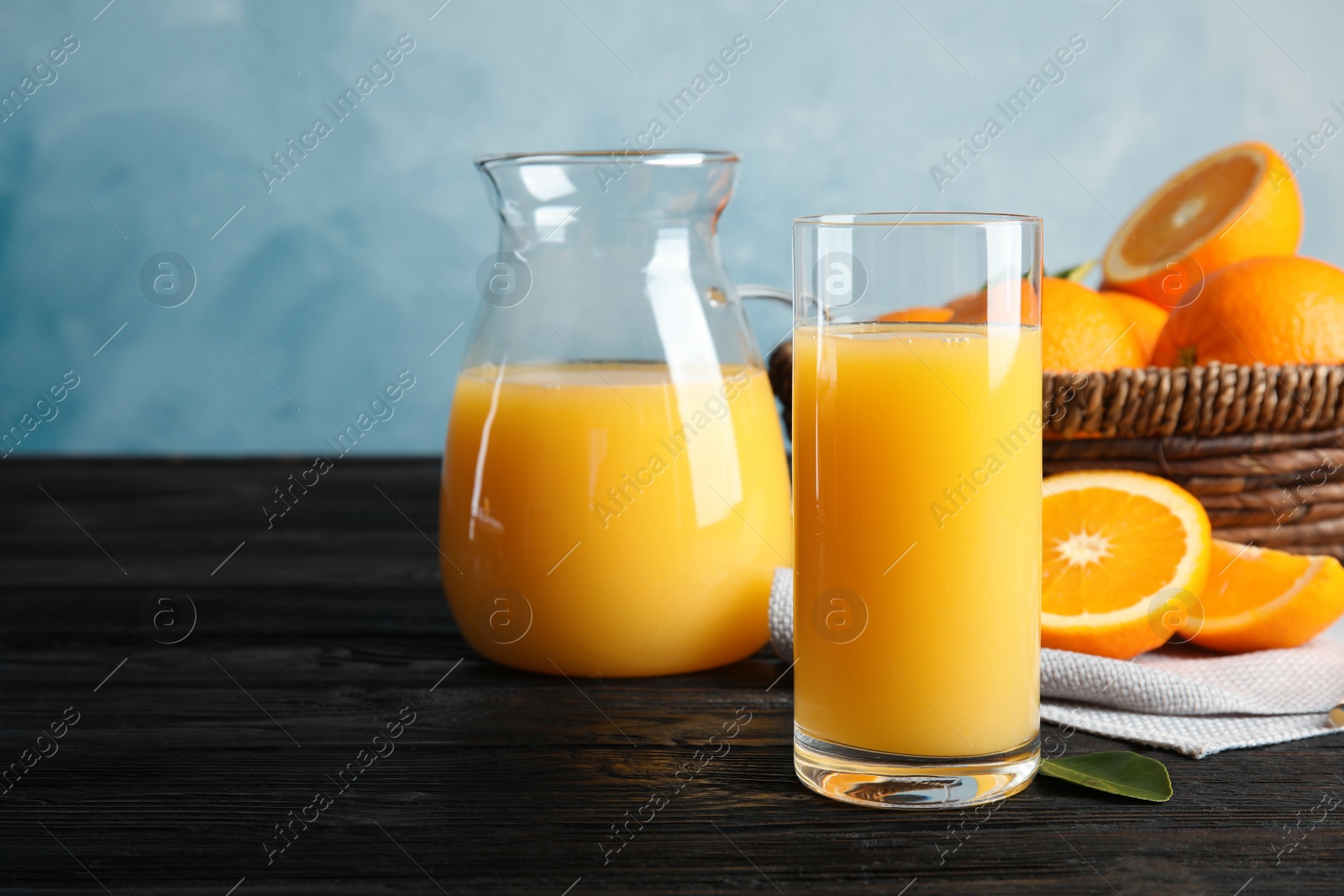 Photo of Composition with orange juice and fresh fruit on table, space for text