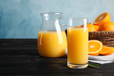 Photo of Composition with orange juice and fresh fruit on table, space for text