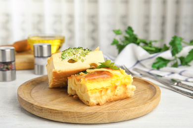 Tasty broccoli casserole served on white wooden table indoors